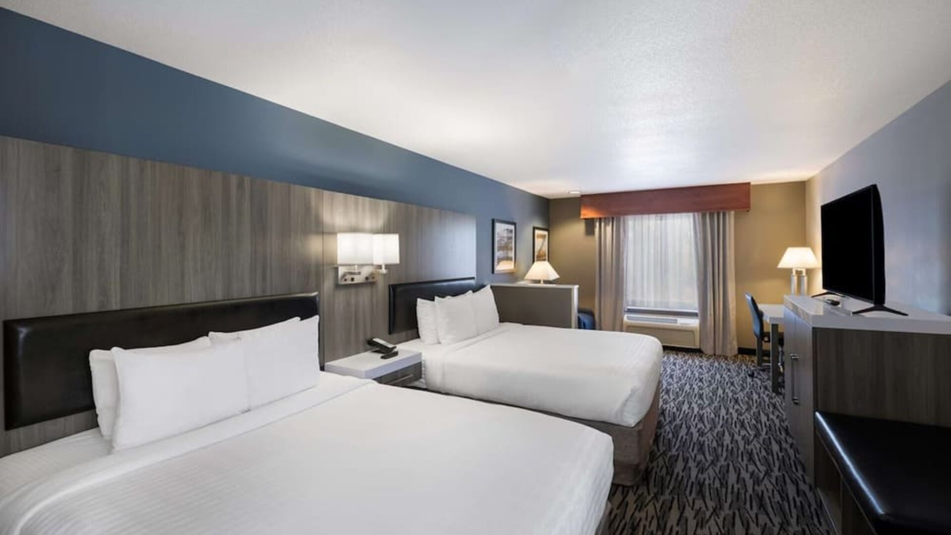 uest room with two beds, television, dresser, and seating area at Best Western Plus Mountain View Auburn Inn.