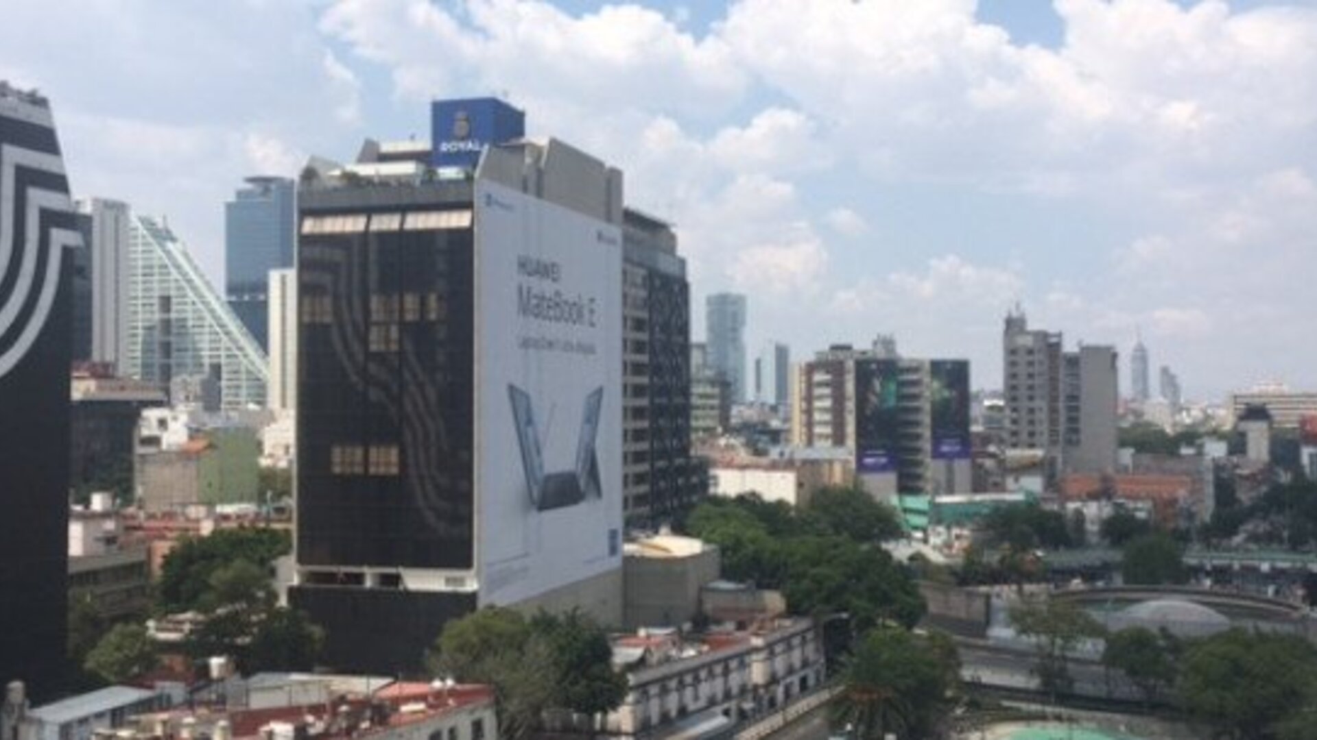 View of Mexico City’s modern skyscrapers and surrounding urban buildings through the windows at Hotel Block Suites.