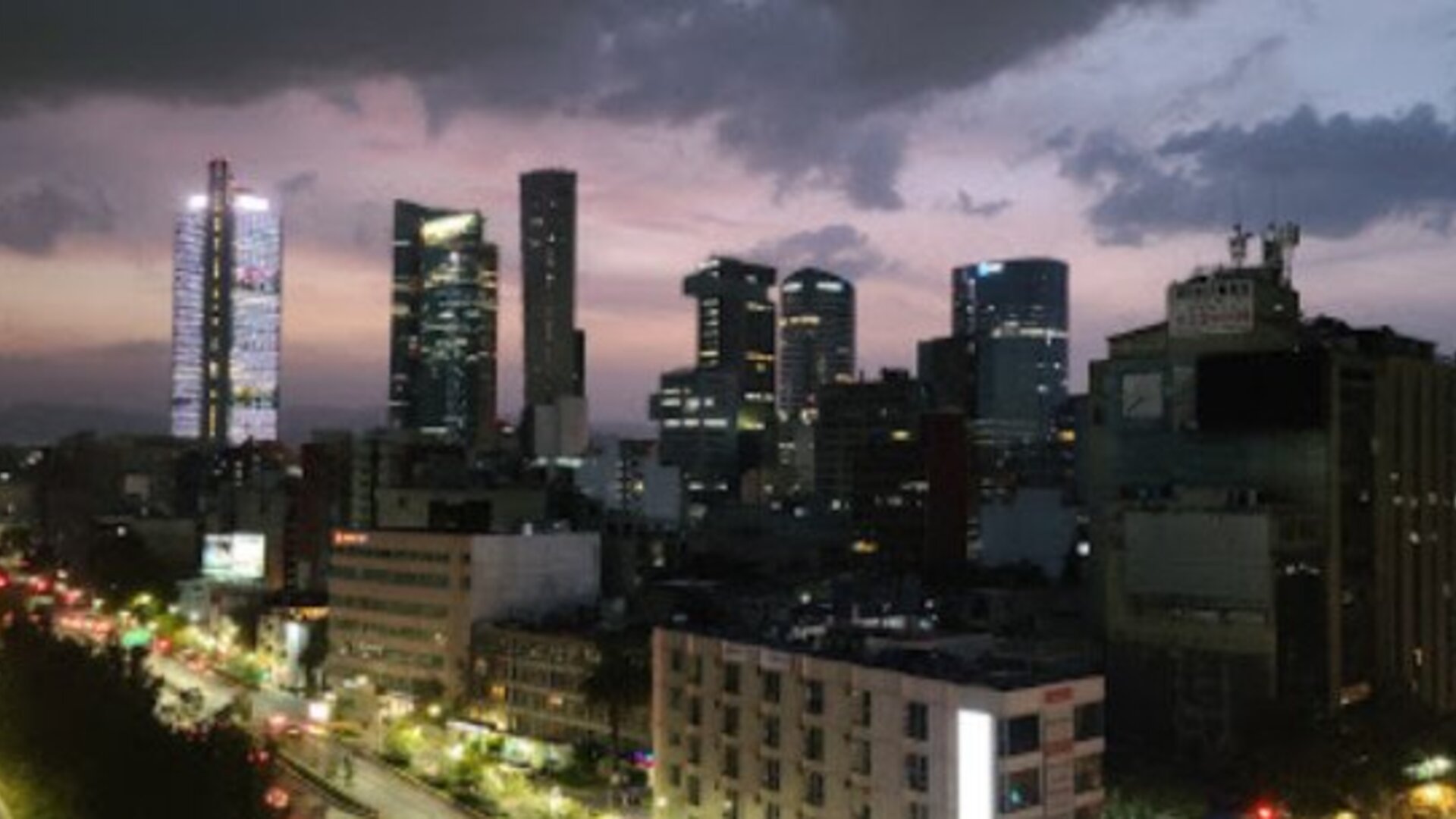 Panoramic nighttime view of Mexico City’s illuminated skyline and busy streets at Hotel Block Suites.