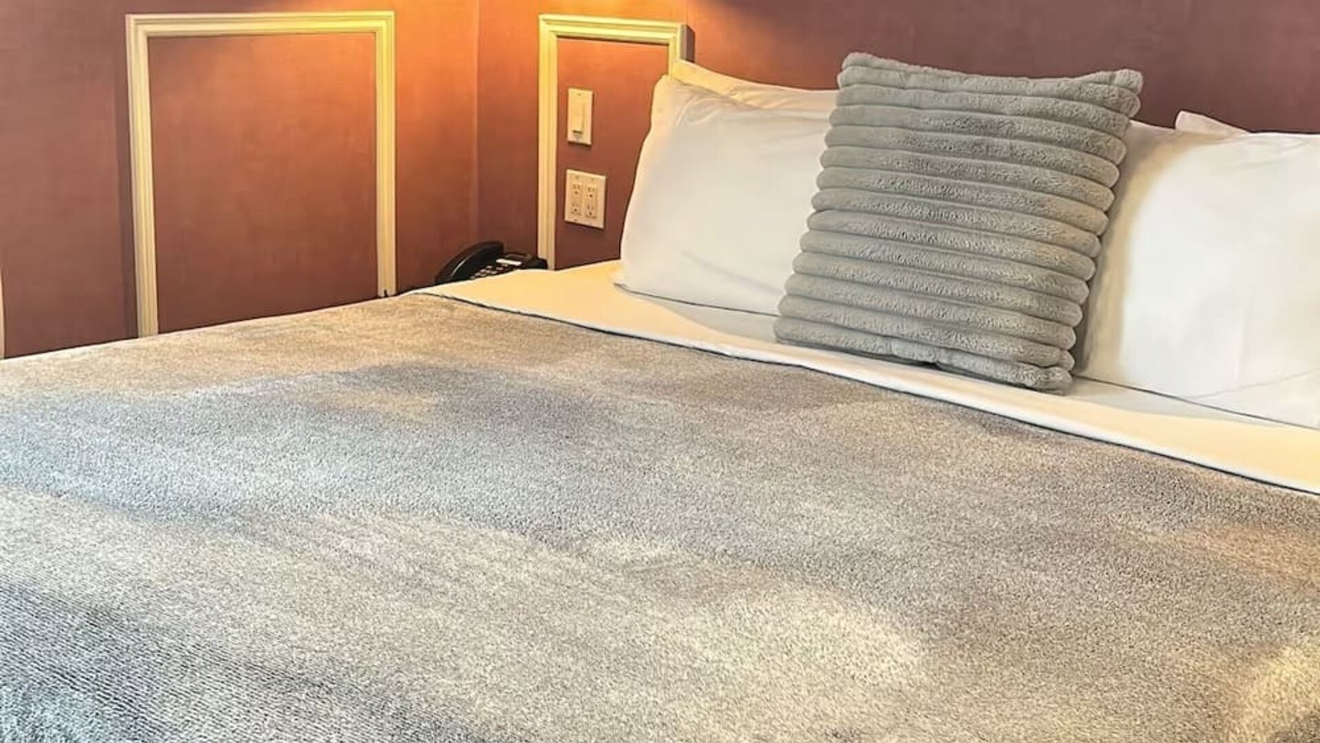 King bed at Parc Suites Hotel.