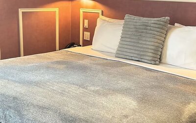 King bed at Parc Suites Hotel.