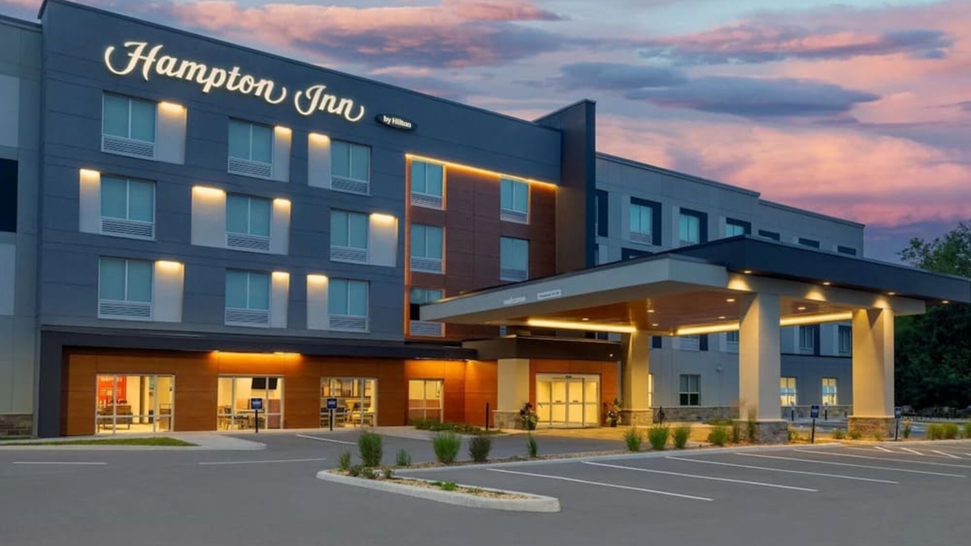Hotel exterior and parking area at Hampton Inn By Hilton Port Hope.