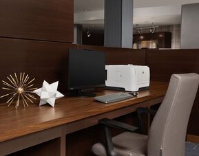 Business center with computer monitor, printer, keyboard, decorative ornaments and a wooden workstation at Courtyard By Marriott Dothan.