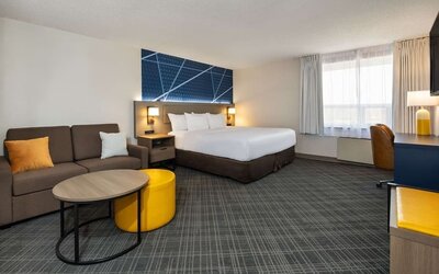 Day use room with work desk, TV, sofa and private bathroom at Comfort Inn & Suites Barrie.