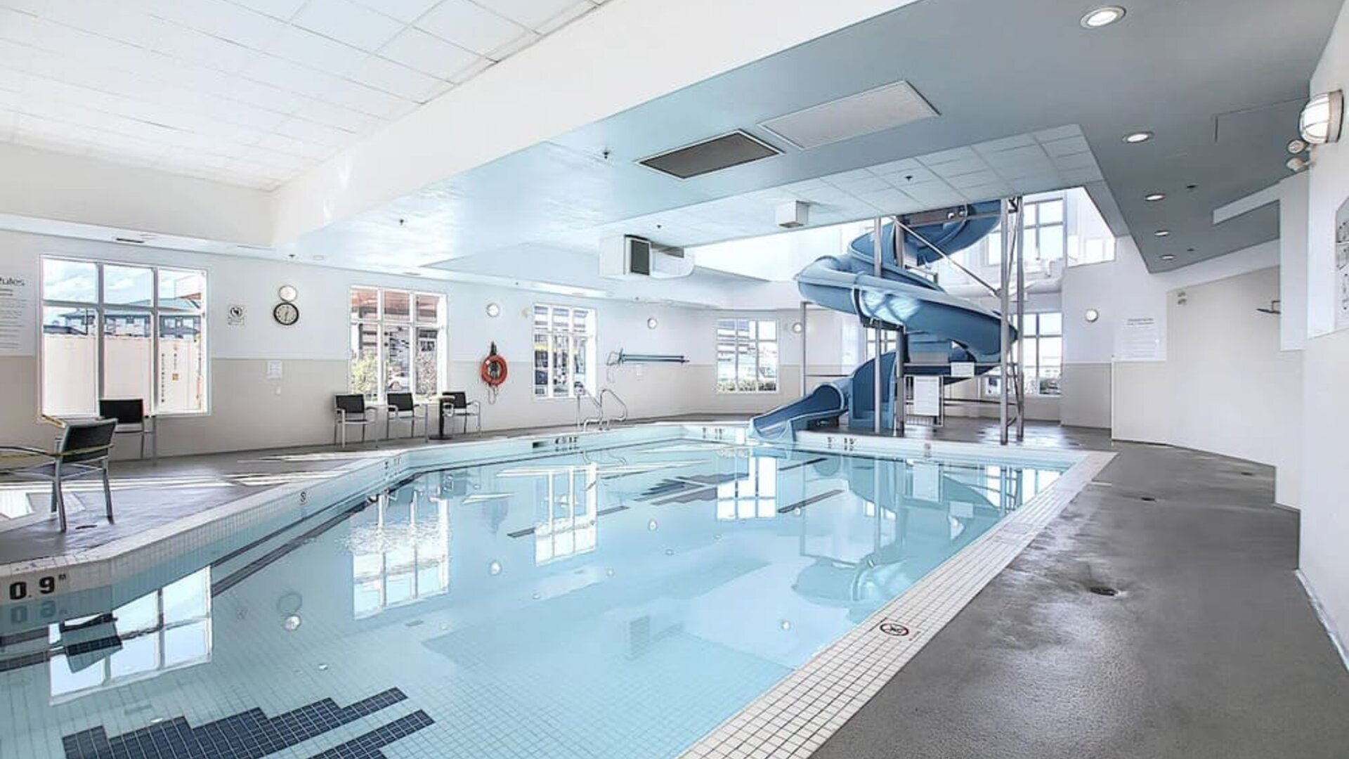 Indoor pool with lounge chairs at Holiday Inn Express & Suites Airport-Calgary.