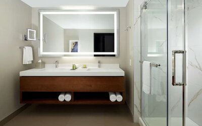 Private guest bathroom with shower and toiletries at DoubleTree By Hilton Montreal Airport.