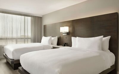 Twin room with private bathroom at the Embassy Suites by Hilton Montreal Airport.