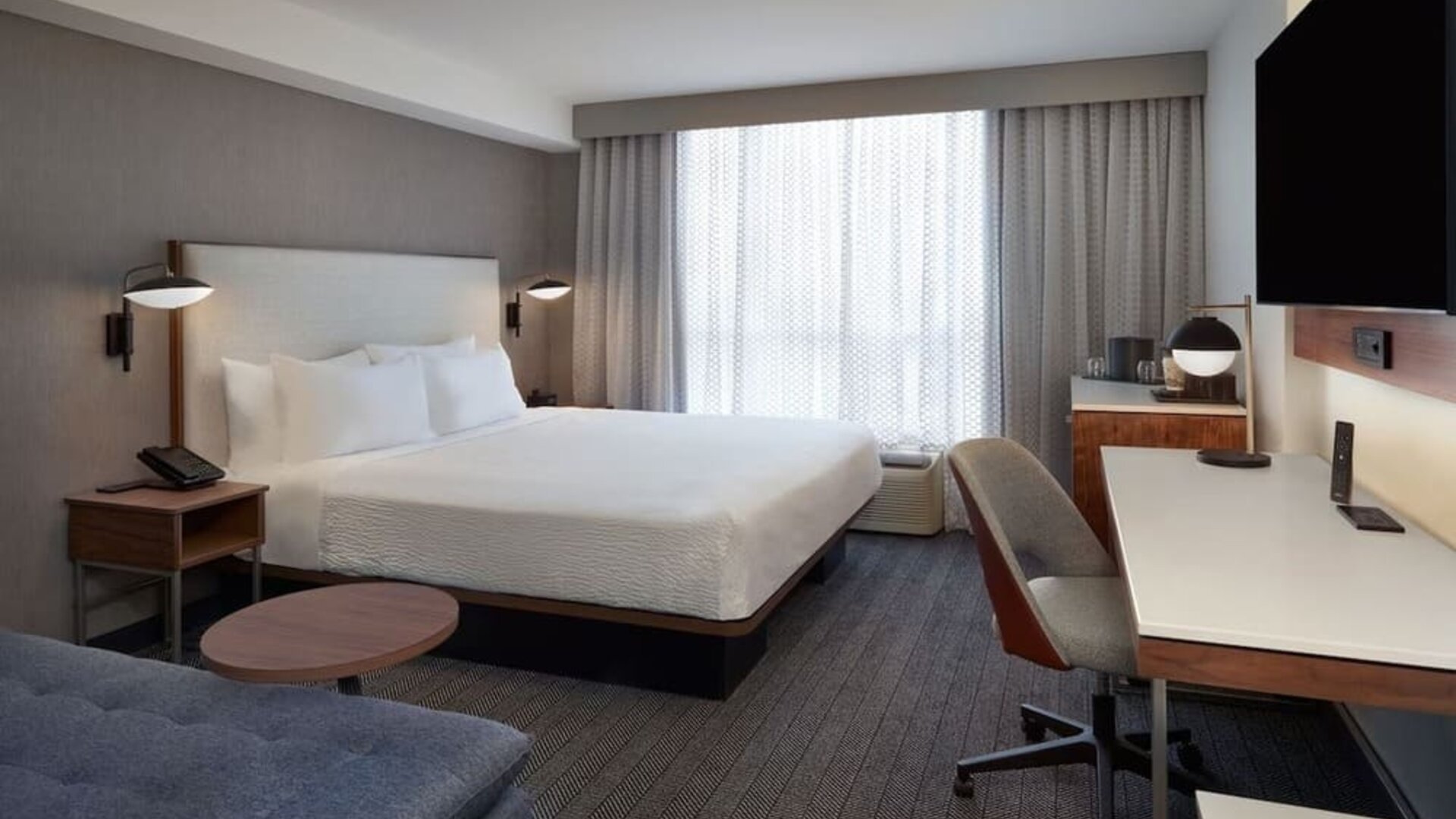 Day use room with work desk and sofa at Courtyard By Marriott Kitchener.