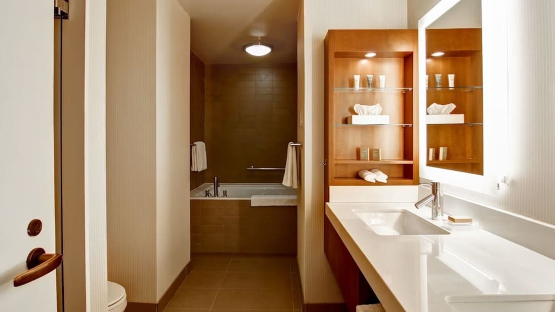 Private guest bathroom with tub and toiletries at Hilton Mississauga Meadowvale.