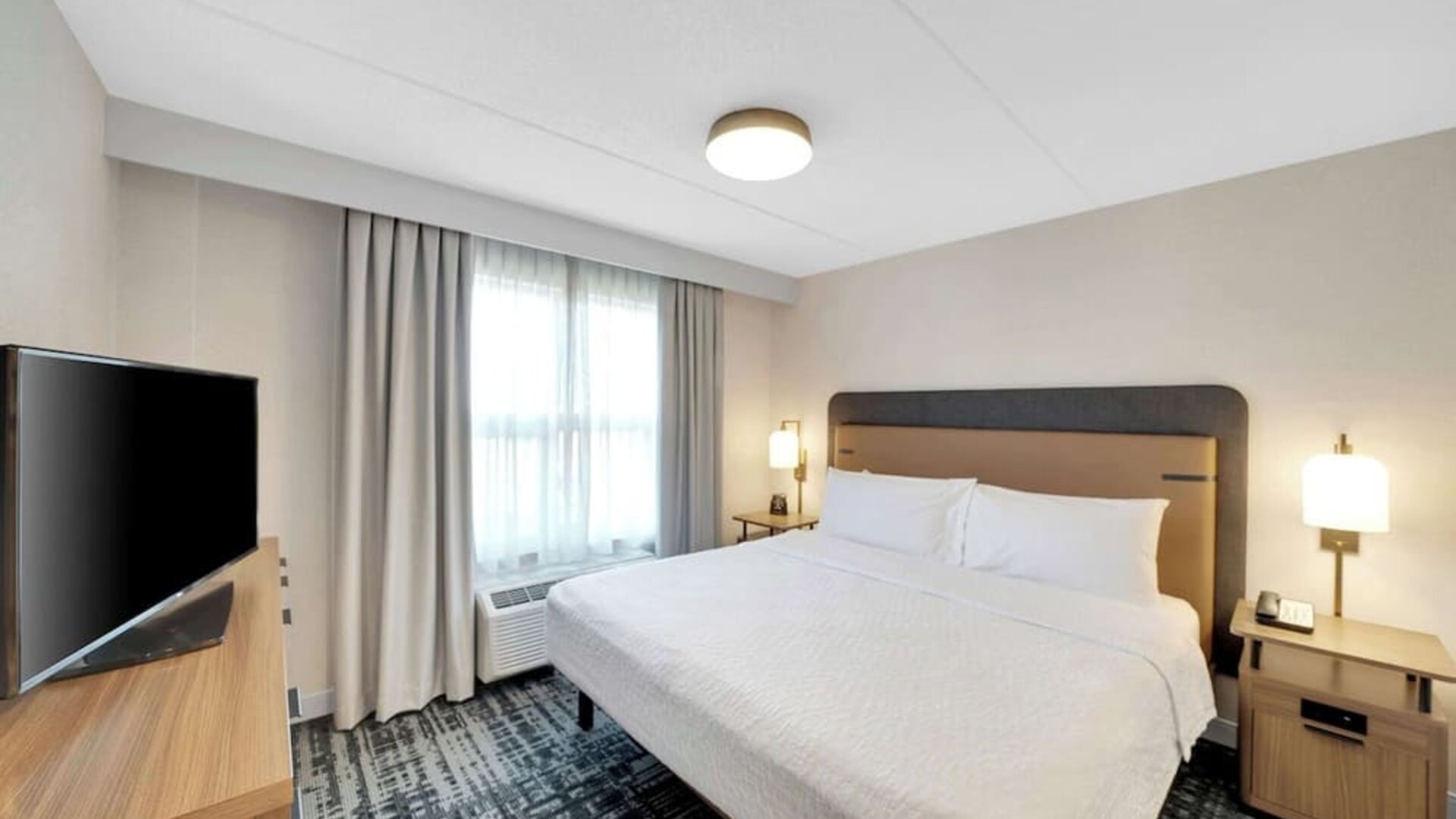 Standard day use room with king bed, work desk, TV and private bathroom at Homewood Suites By Hilton Toronto-Markham.