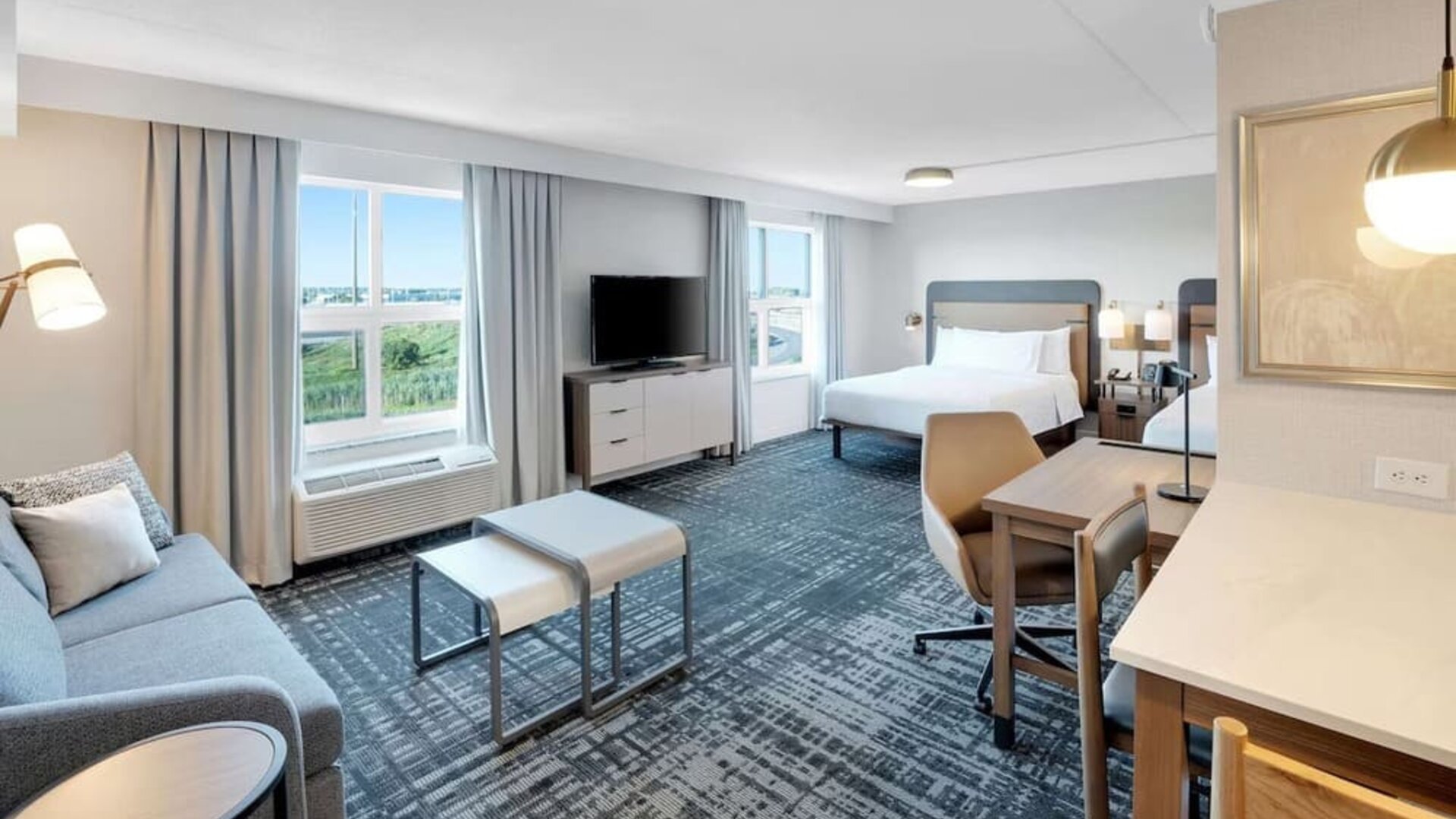 Twin day use room with lounge area and in-room kitchen at Homewood Suites By Hilton Toronto-Markham.