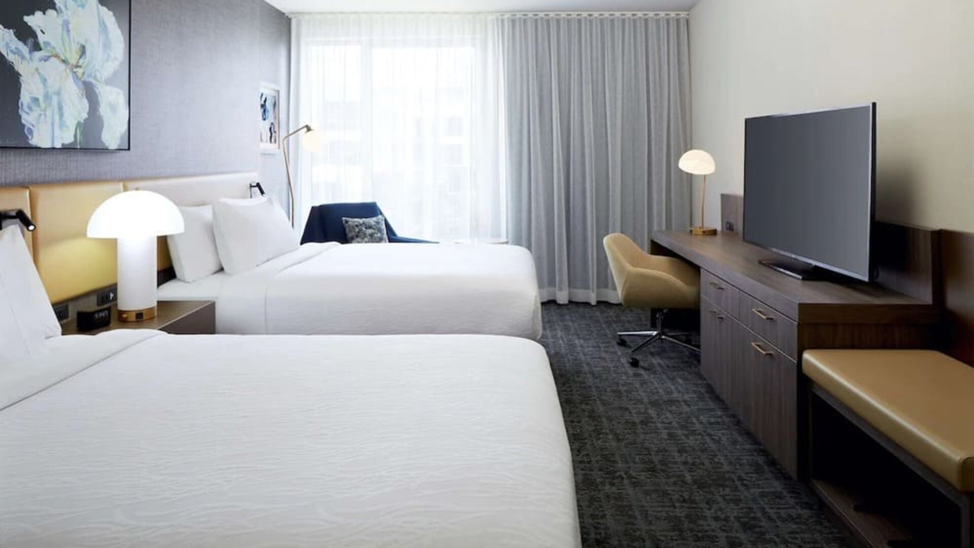 Day use twin room with TV, work desk and lounge area at Hilton Garden Inn Montreal Midtown.