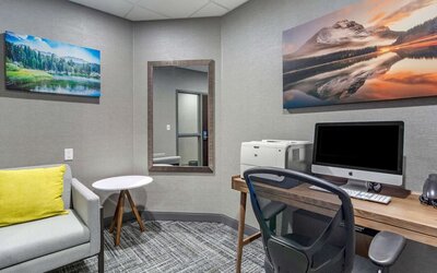 Business center with computer, printer, phone and comfortable mobiliary at Hampton Inn & Suites By Hilton Edmonton/West.