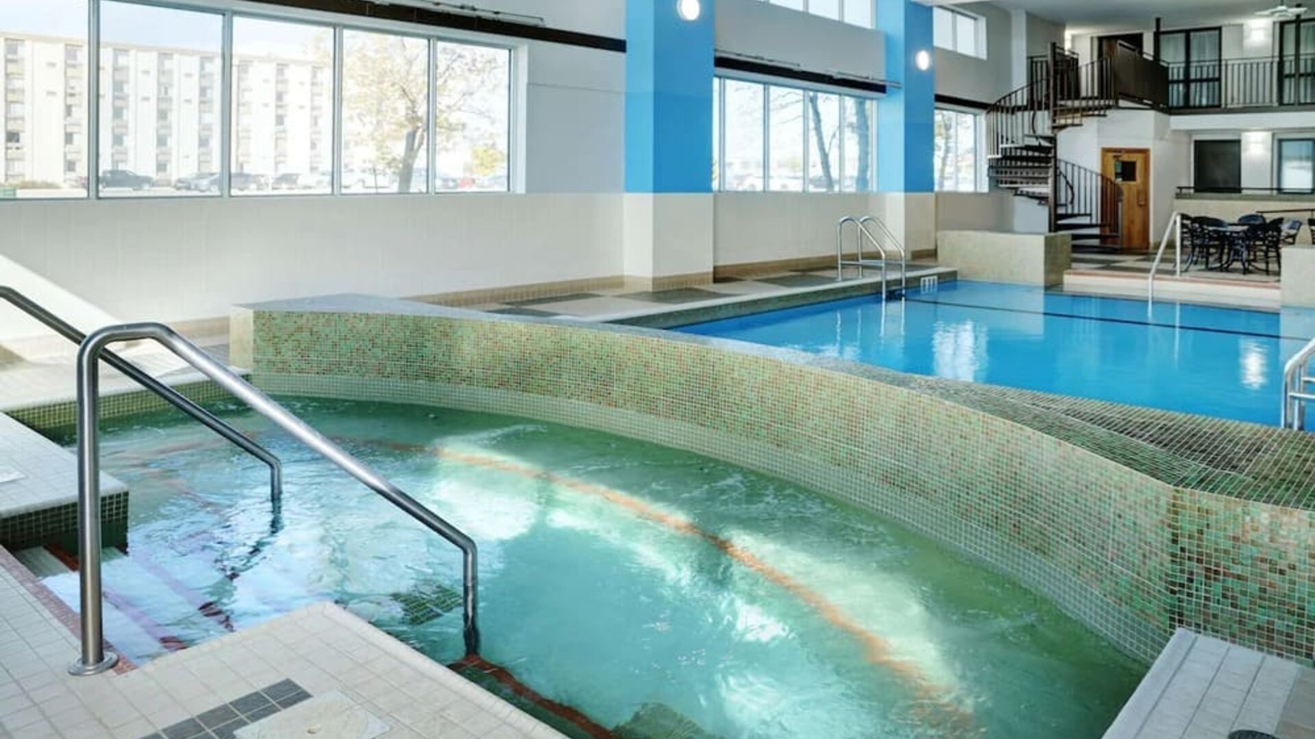 Indoor pool with jacuzzi at Hilton Winnipeg Airport Suites.