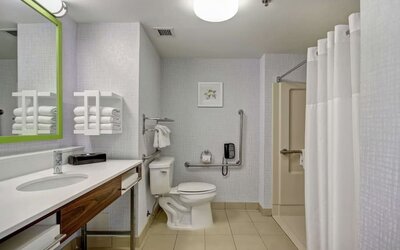 Private guest bathroom with shower and free toiletries at the  Hampton Inn & Suites By Hilton Guelph.