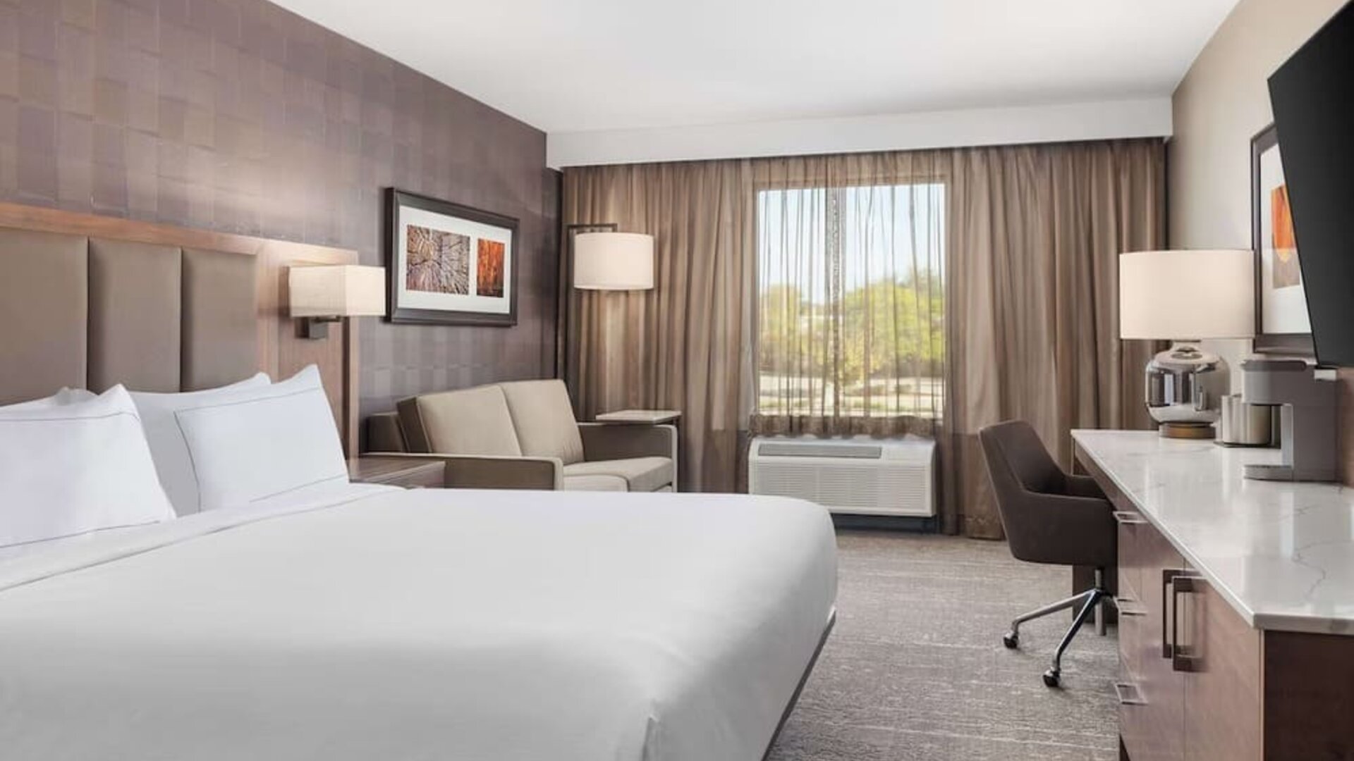 Day use room with TV, work desk, sofa and private bathroom at DoubleTree By Hilton Kitchener.
