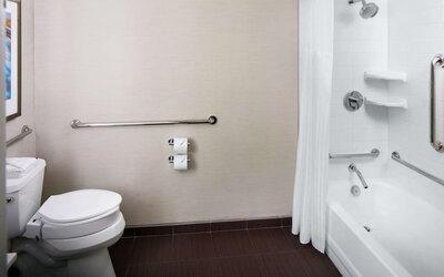 Guest bathroom with shower and tub at Hilton Albany.
