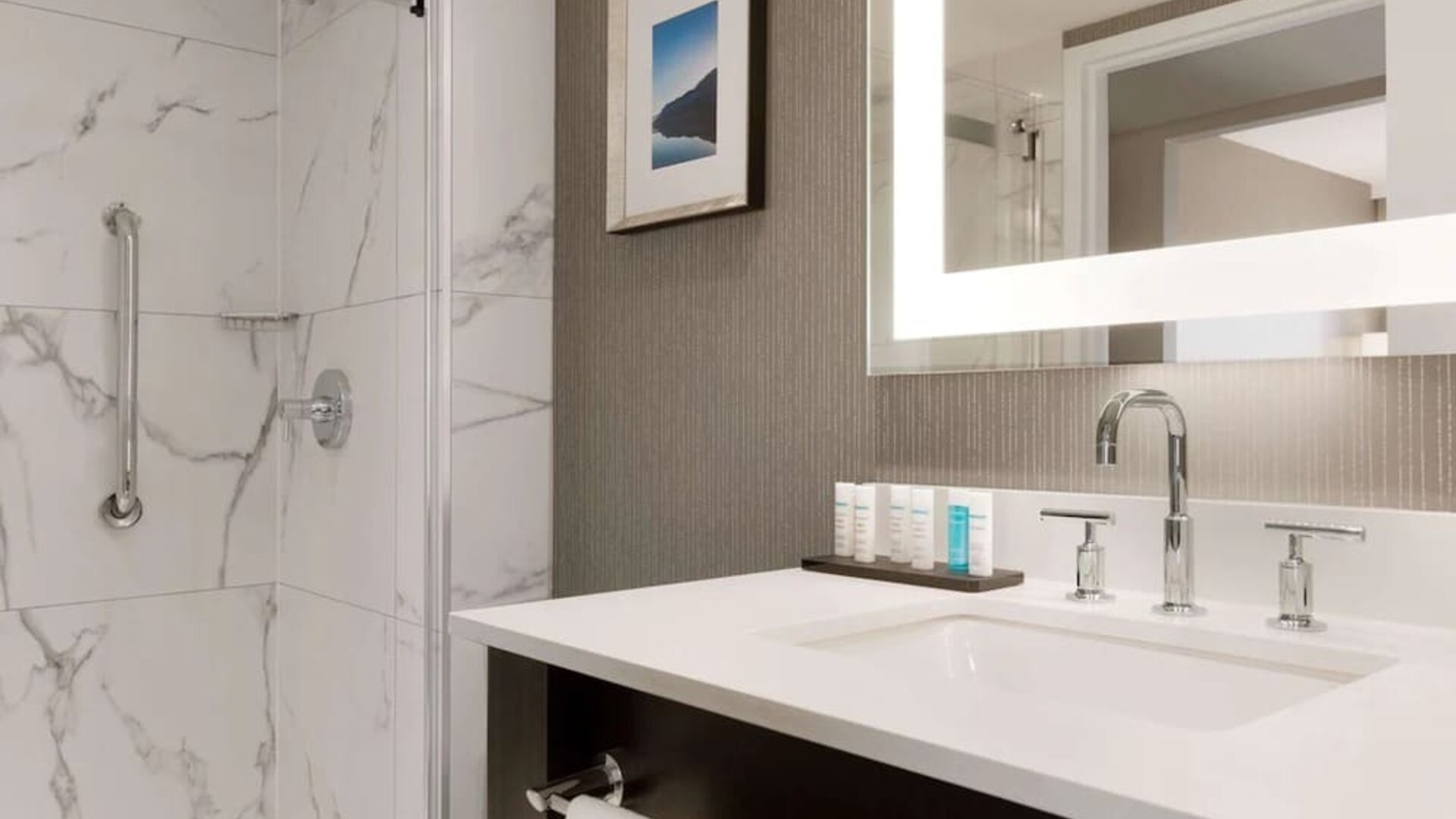 Private guest bathroom with shower and free toiletries at the Embassy Suites By Hilton Toronto Airport.