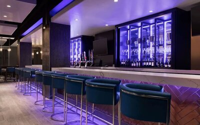 Hotel bar with lounge chairs at the Embassy Suites By Hilton Toronto Airport.
