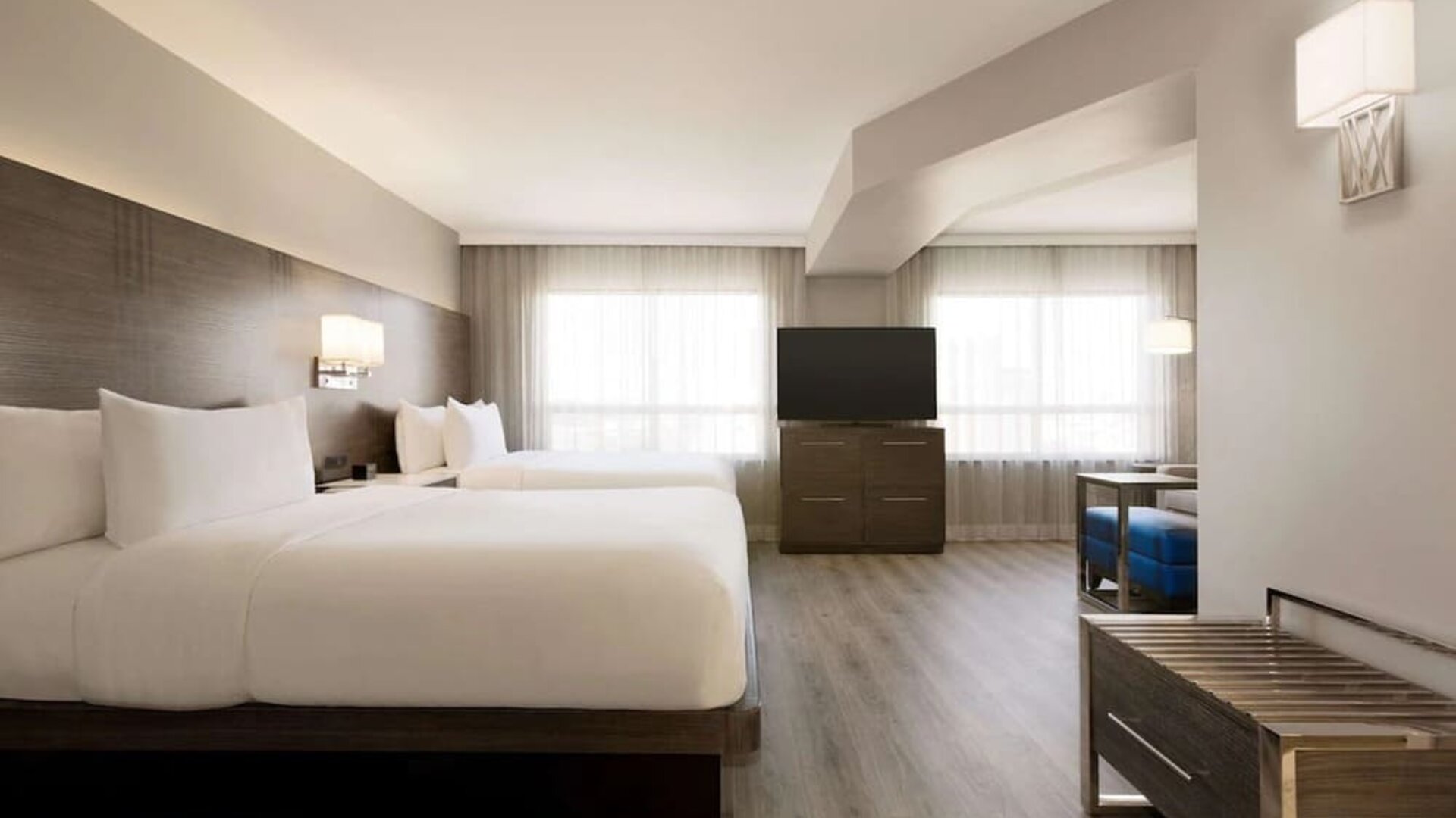 Day use twin room with TV screen, lounge area and work space at the Embassy Suites By Hilton Toronto Airport.