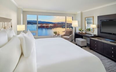 Day use room with TV, work desk, sofa and private bathroom at the Fairmont Waterfront.