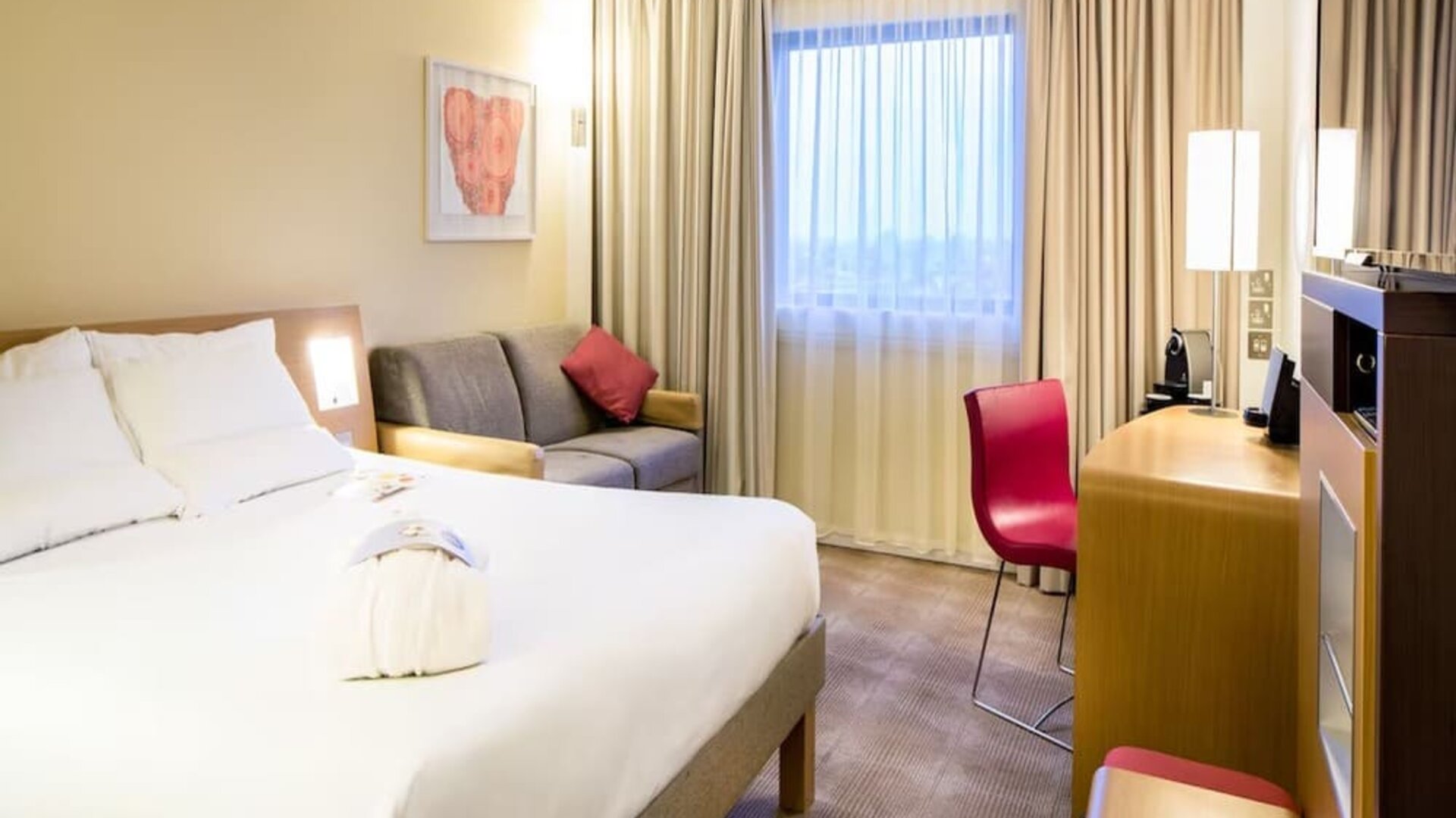 Day use room with work desk and sofa at Novotel London Paddington.
