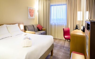 Day use room with work desk and sofa at Novotel London Paddington.
