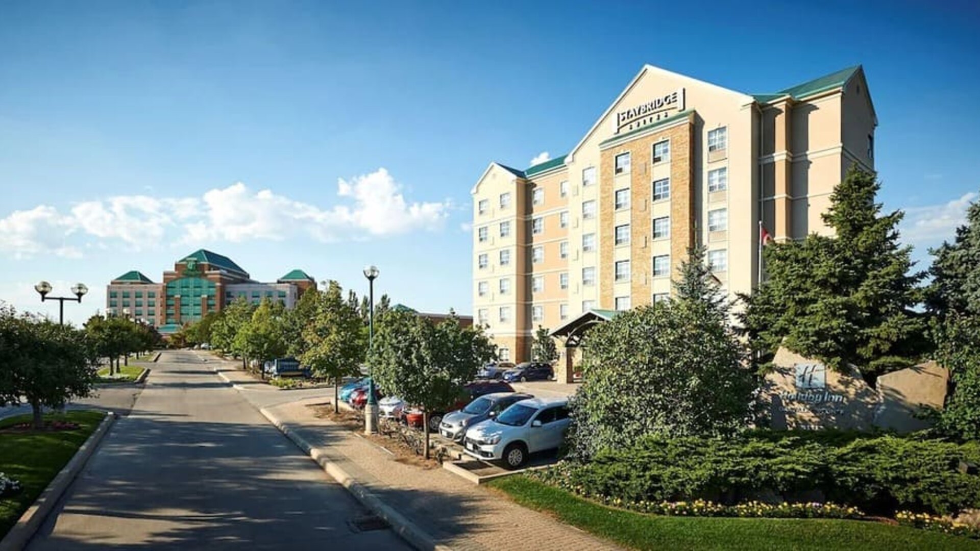Hotel exterior with parking area at Staybridge Suites Oakville-Burlington.
