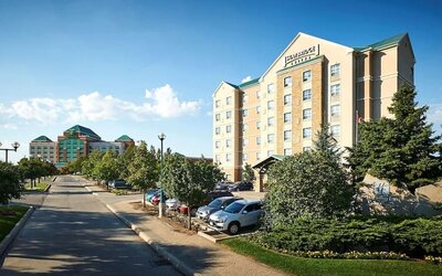 Hotel exterior with parking area at Staybridge Suites Oakville-Burlington.