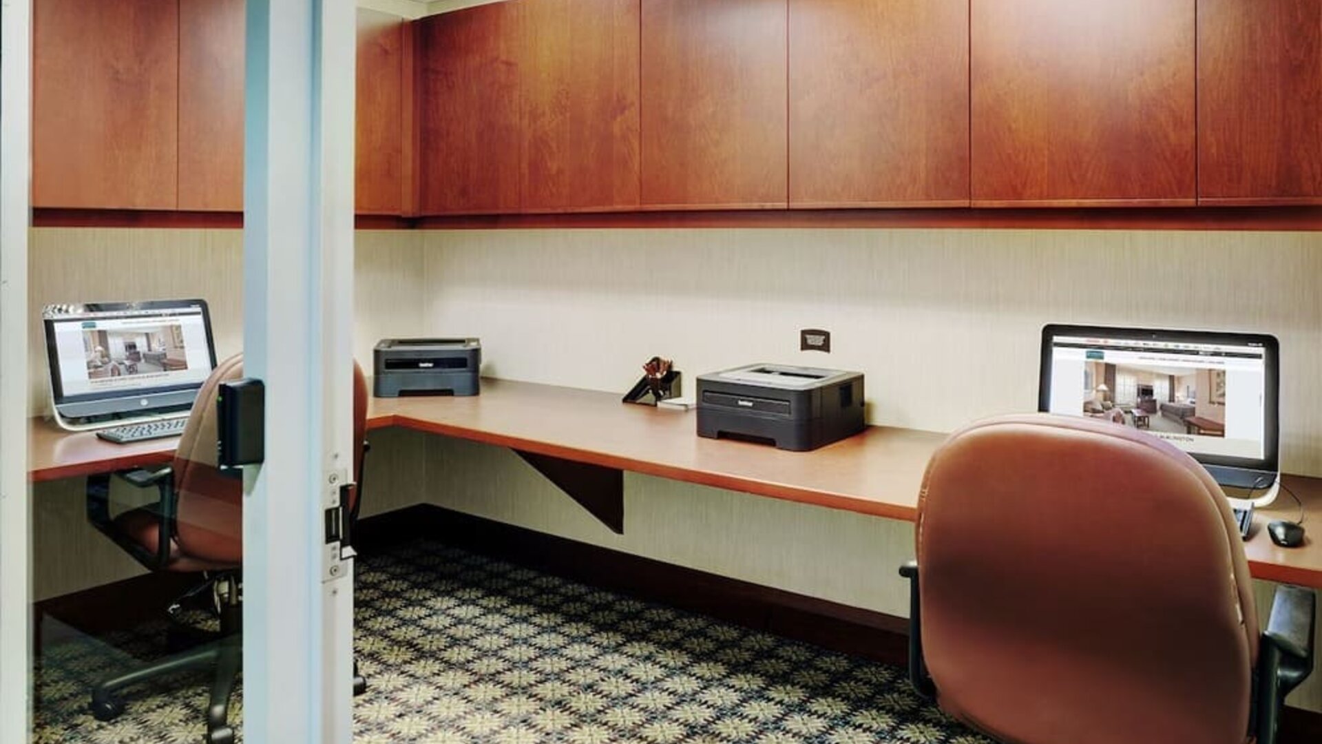 Business center with computers, printers and ergonomic chairs at Staybridge Suites Oakville-Burlington.
