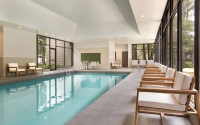 Relaxing indoor pool with lounge chairs at DoubleTree By Hilton Hotel Toronto Airport West.