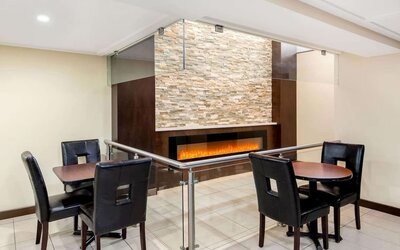 Dining area with fireplace at La Quinta Inn & Suites By Wyndham Oshawa.