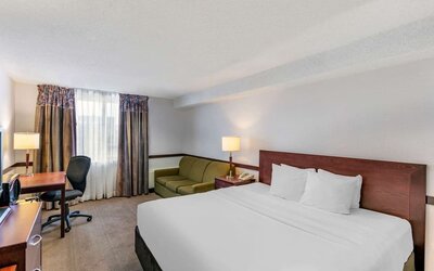 Day use room with TV, sofa, work desk and private bathroom at Hampton Inn by Hilton Montreal East Anjou.