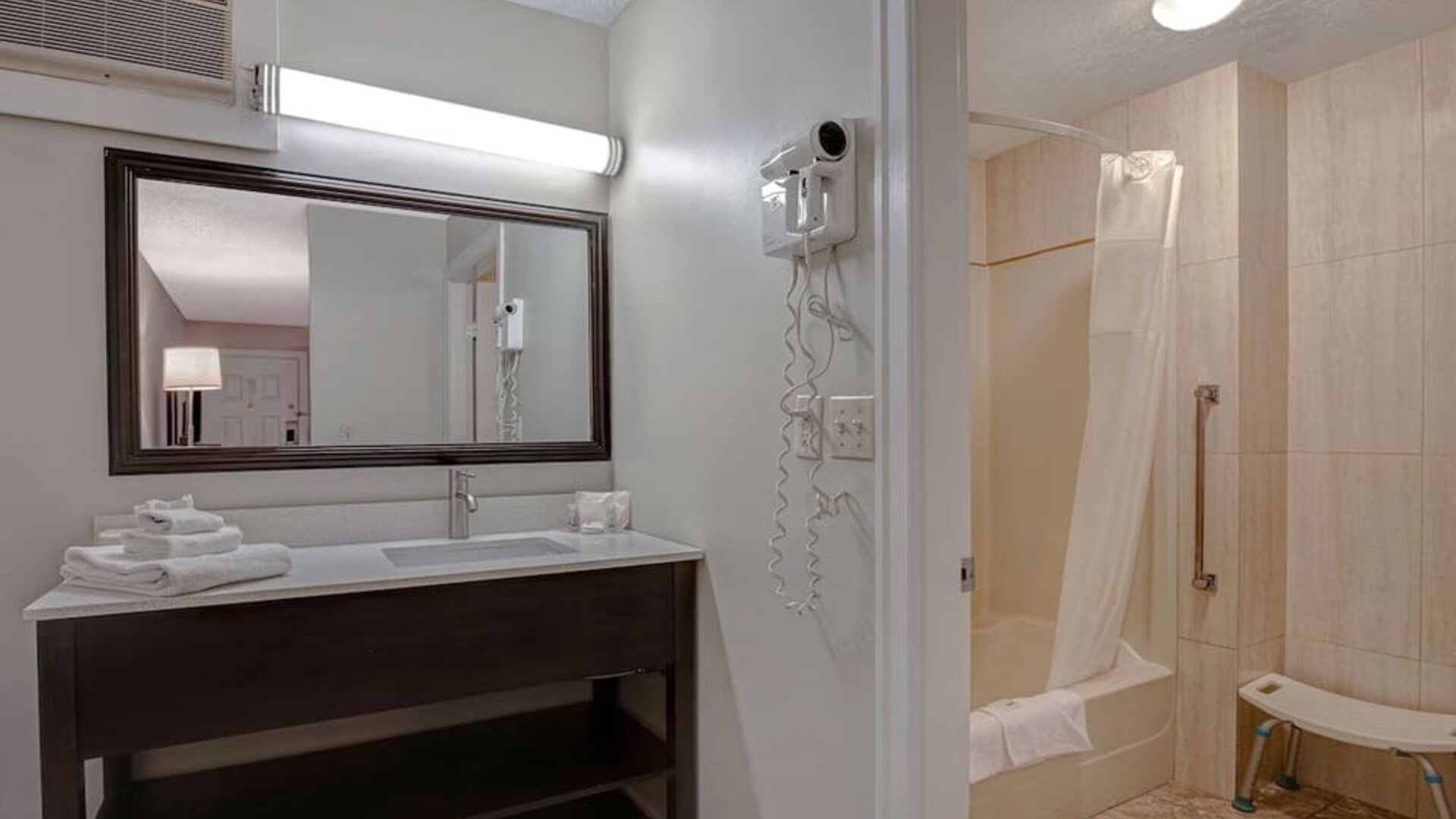 Private guest bathroom with shower and free toiletries at Days Inn Vernon.