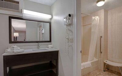 Private guest bathroom with shower and free toiletries at Days Inn Vernon.
