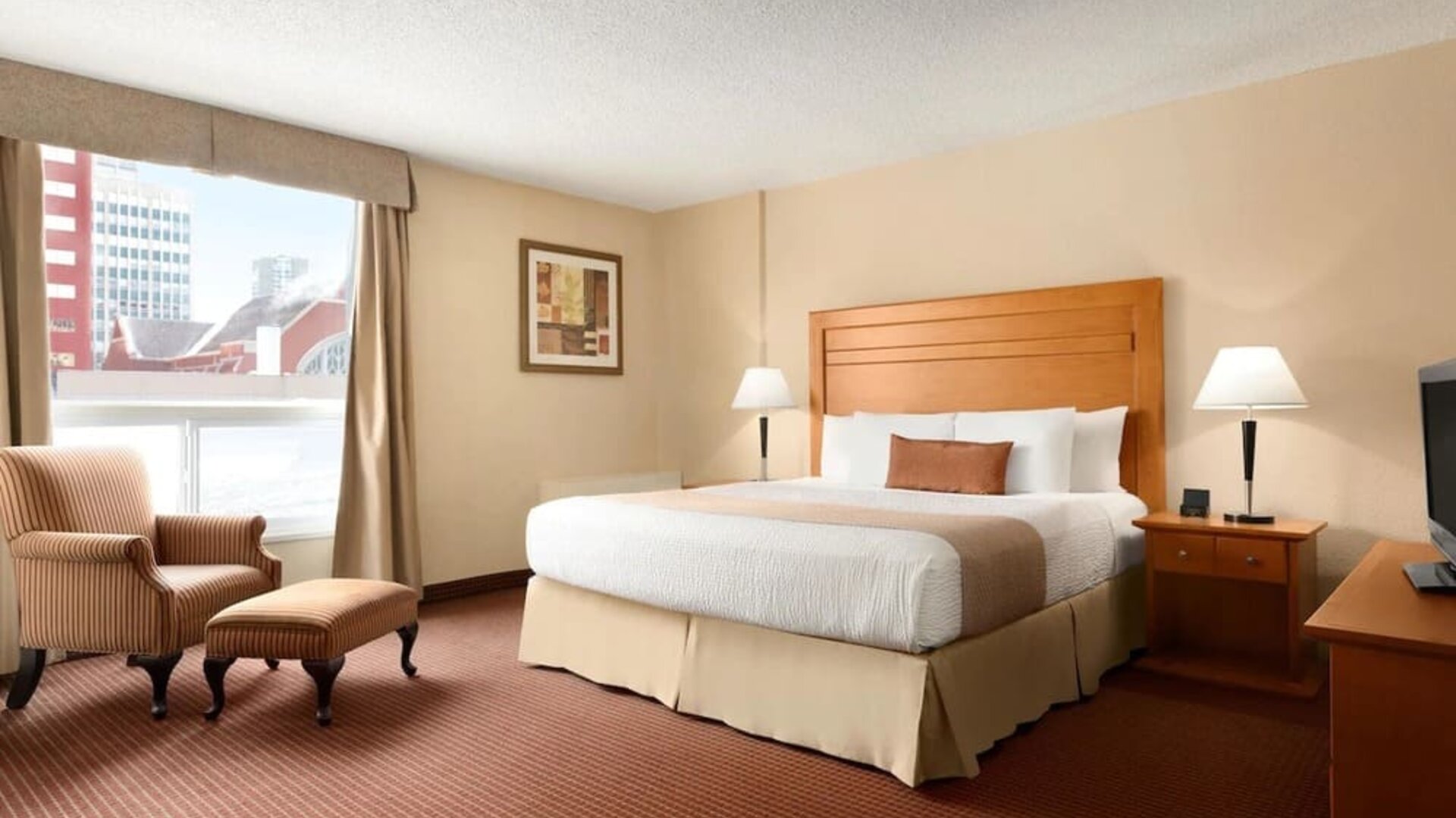 Day use room with TV, sofa, work desk and private bathroom at Days Inn Edmonton Downtown.