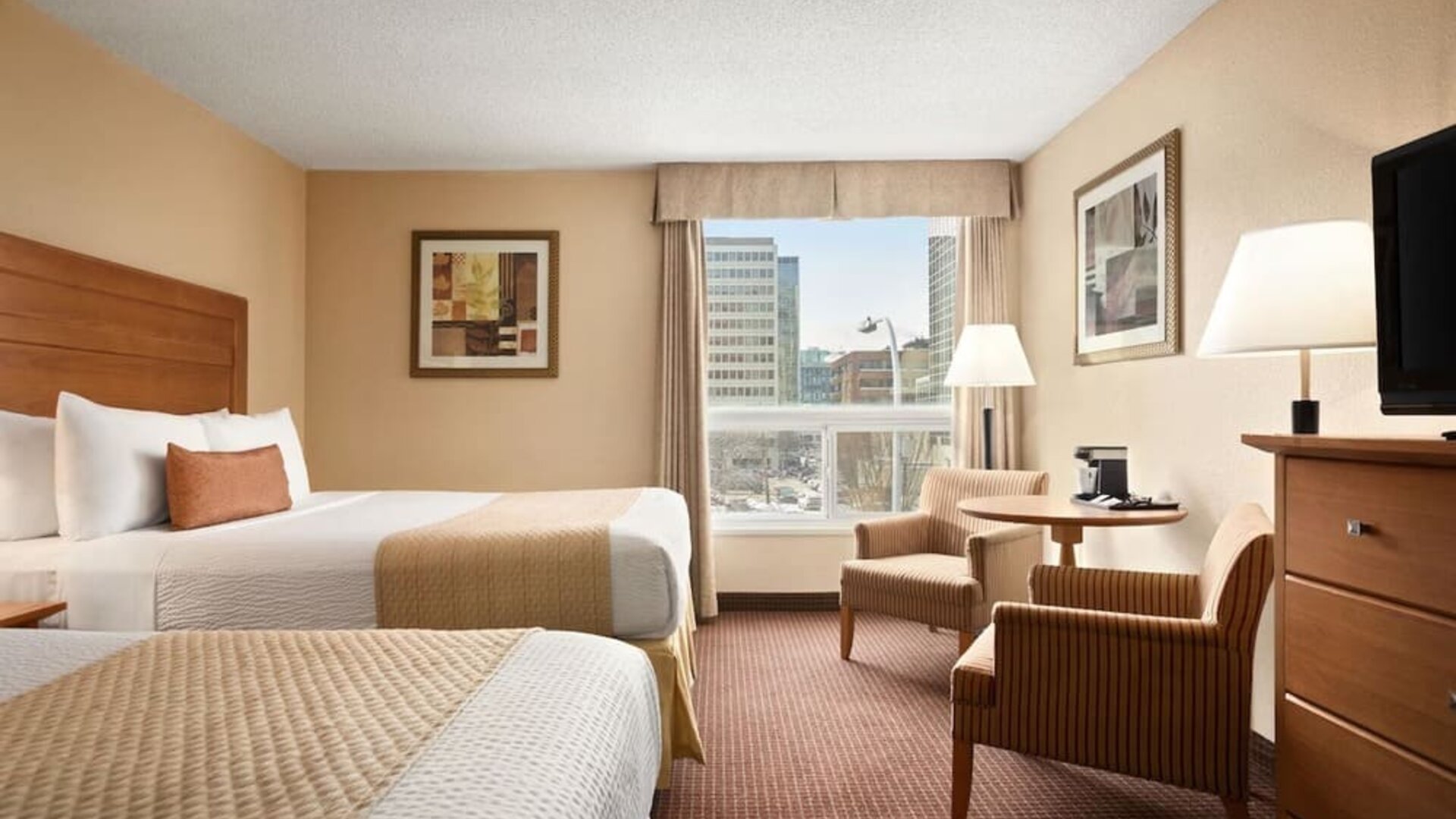 Day use twin room with TV, sofas, large window and private bathroom at Days Inn Edmonton Downtown.