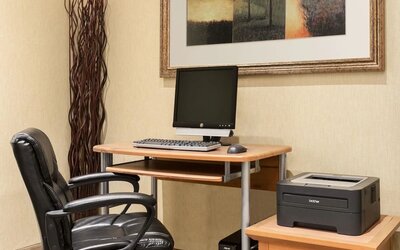 Business center with computer, printer and ergonomic chair at Days Inn Edmonton Downtown.