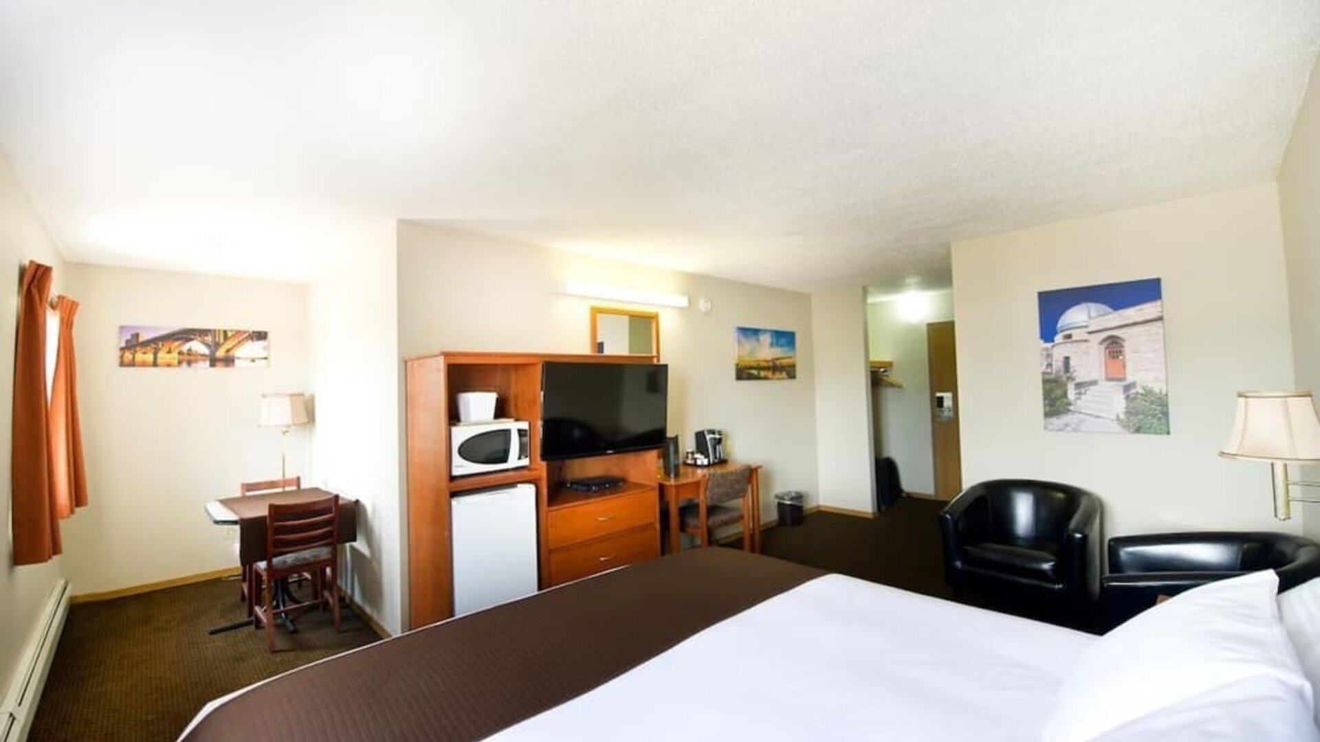 Day use room with TV, tables, sofas, mini bar, microwave and private bathroom at Riviera Motor Inn.