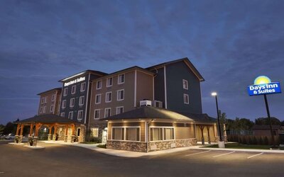 Hotel exterior and parking area at Days Inn & Suites By Wyndham Lindsay.
