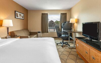 Day use room with TV, sofa, work desk and private bathroom at Comfort Inn Simcoe.