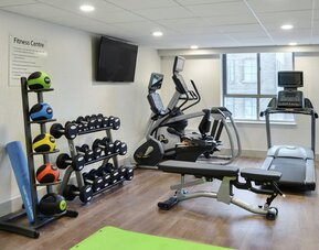 Fully equipped fitness center at Holiday Inn Express Toronto Downtown.