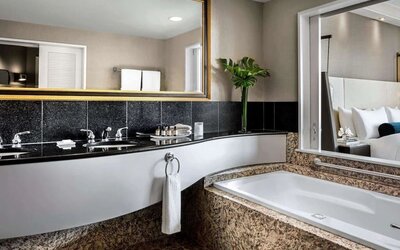 Guest bathroom with tub and free toiletries at Fairmont Vancouver Airport - YVR Terminal Hotel.