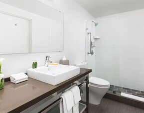 Guest bathroom with shower at YVE Hotel Miami.