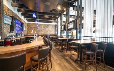 Hotel bar with lounge seating at Acclaim Hotel Calgary Airport.