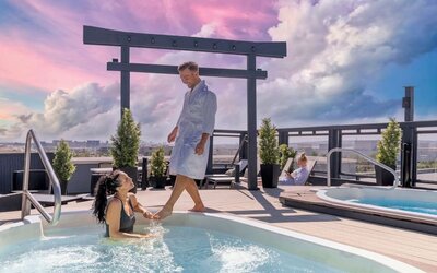 Hotel terrace with outdoor pool and hot tub at Acclaim Hotel Calgary Airport.