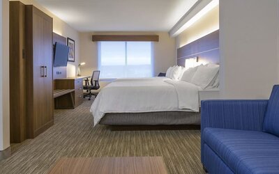 Day use room with TV, work desk, living area and private bathroom at Holiday Inn Express & Suites North Bay.