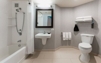 Guest bathroom with shower and tub at Courtyard By Marriott Los Angeles LAX/Century Boulevard.