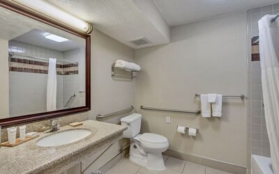 Guest bathroom with shower and tub at Radisson Hotel Salt Lake City Airport.