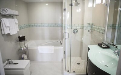 Guest bathroom with shower and tub at The Mutiny Hotel.